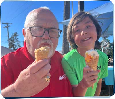 John shares an ice cream cone with his grandson